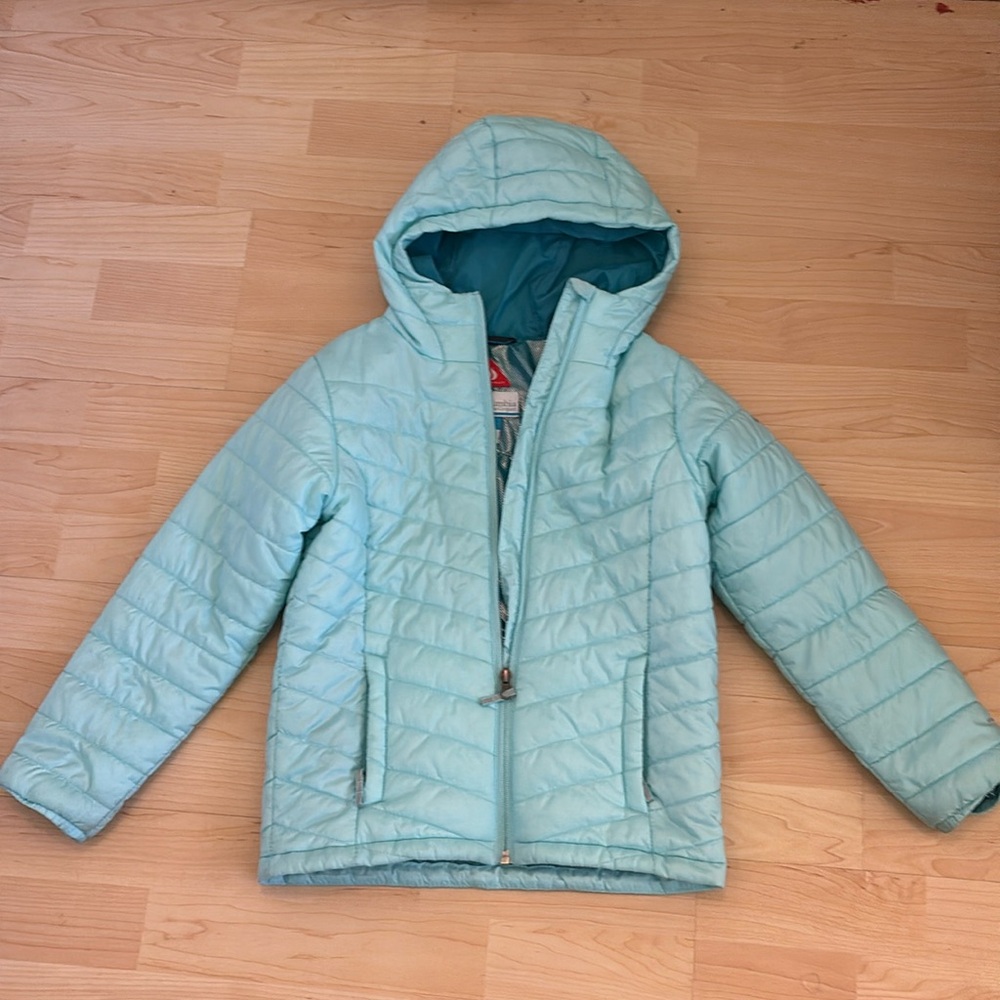 A cyan colored puffer jacket